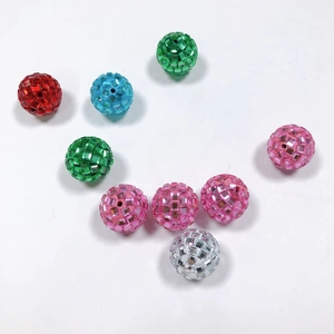Macro shot of colorful sparkling disco beads with facets for DIY jewelry making