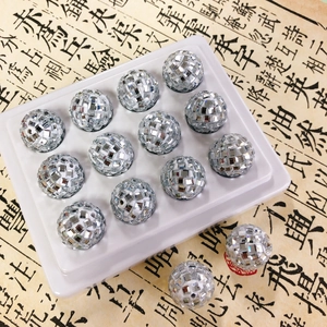 Close-up of sparkling silver disco mirror mosaic beads for DIY jewelry and crafts