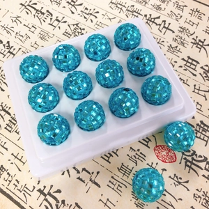 Macro detail of brilliant blue disco ball beads with square-cut sparkling rhinestones