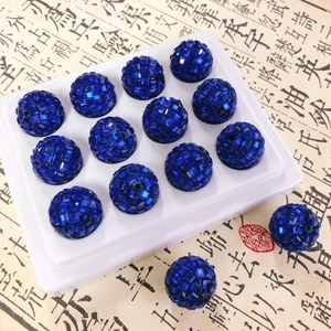 Macro shot of 14 blue disco ball spacer beads with shiny faceted surface for DIY crafts
