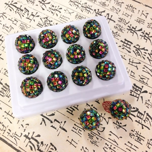 Close-up of vibrant mosaic-style disco ball beads with colorful glitter tiles for DIY crafts