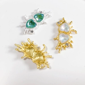 Detailed view of alloy heart charms with sparkling rhinestones and liquid metal frames