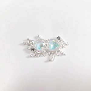 Detail of silver liquid metal heart pendant with Aurora Borealis crystals and rhinestones