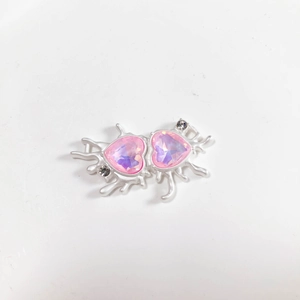 Detail of pink heart crystal pendant with silver liquid metal frame for DIY jewelry