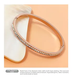 Detailed macro view of a rose gold titanium steel bangle with shimmering cubic zirconia