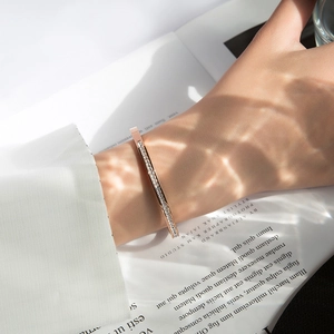 Rose gold titanium steel bracelet with full sparkling zircons on a model's wrist