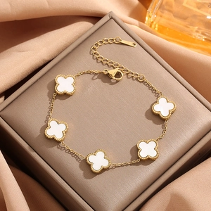 18K gold plated clover bracelet with five white mother of pearl motifs on silk background