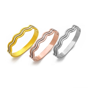 Polished wave-patterned bangles with rhinestones in gold, rose gold, and silver finishes