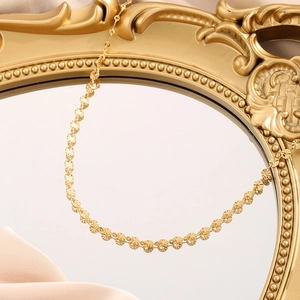 Polished gold titanium steel necklace with radial pattern round discs on vintage mirror