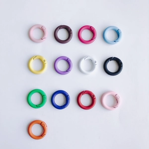 Detailed grid of 13 colorful matte round spring rings for DIY bag and keychain accessories