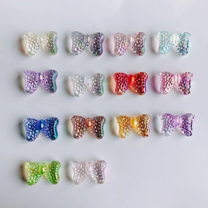 Detailed grid of colorful resin butterfly pendants for DIY crafts and jewelry