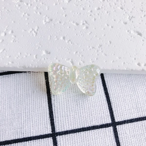 Macro shot of iridescent acrylic butterfly charms with a textured finish for DIY jewelry