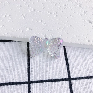 Detailed close-up of a translucent iridescent butterfly bead for DIY jewelry making