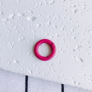 Detail of rose red round spring ring buckle with a matte finish for DIY accessories