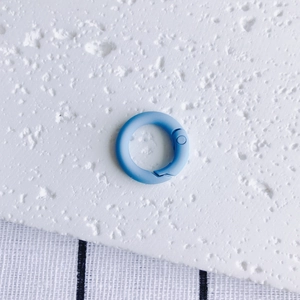 Detail of light blue matte painted round spring ring clasp for DIY keychains and jewelry