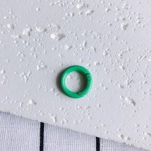 Detail of 20mm bright green spring O-ring with a matte painted finish for DIY crafts