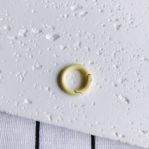 Detail of 20mm matte cream yellow metal spring ring for DIY crafts and keychains