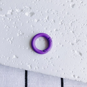 Detail of purple matte round spring snap hook for DIY keychain and bag hardware