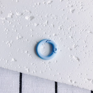 Macro detail of a 20mm light blue matte metal spring O-ring buckle for DIY accessories