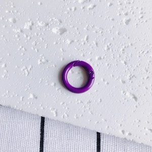 Macro detail of a 20mm purple spring O-ring buckle for keychains and DIY crafts