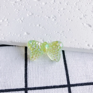 Macro shot of translucent iridescent butterfly charm with textured finish for DIY jewelry
