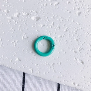 Detail of a turquoise 20mm metal spring O-ring buckle for DIY jewelry and keychains