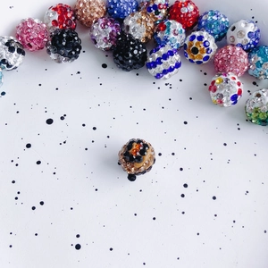 Macro view of 10mm Shamballa-style clay beads with sparkling multi-colored rhinestones