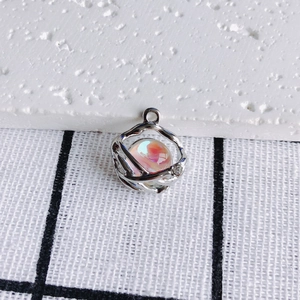 Detail of silver hollow pendant with iridescent bead and rhinestone for DIY jewelry
