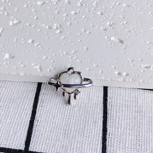 Detailed view of a silver melt heart planet pendant with opal stone for DIY jewelry