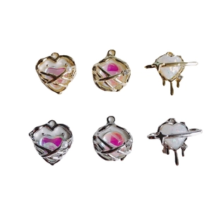 DIY jewelry charms in heart and star shapes with gold and silver finishes and pearls