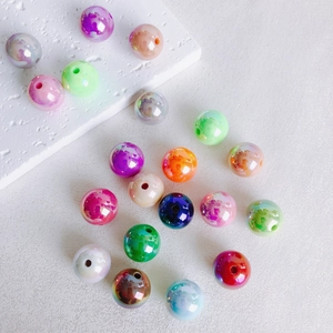 Close-up of 16mm colorful iridescent acrylic beads for DIY jewelry making and crafting