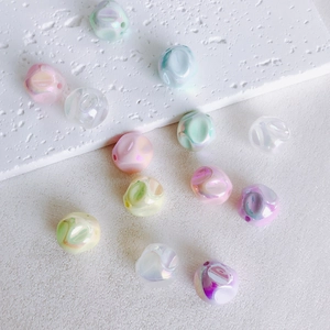 Close-up of 16mm iridescent macaron acrylic beads with textured surface for DIY jewelry