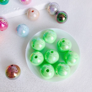 Macro detail of 16mm colorful acrylic beads with pearlescent finish for DIY jewelry