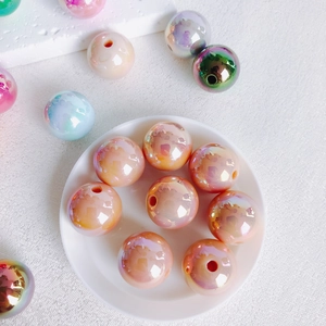 Macro detail of 16mm colorful aurora acrylic beads with central hole for DIY jewelry making