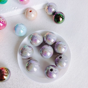 Macro shot of 16mm iridescent acrylic beads with aurora finish for DIY jewelry