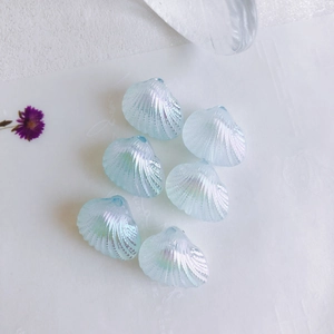 Macro view of light blue iridescent shell beads for DIY jewelry making on white background