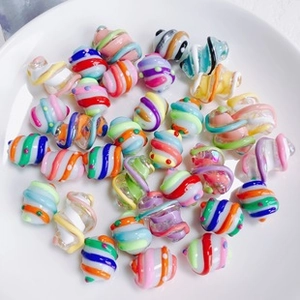 Macro shot of colorful spiral textured glass beads for DIY jewelry making and crafts