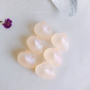 Macro detail of pearlescent shell beads with mermaid finish for DIY jewelry crafts