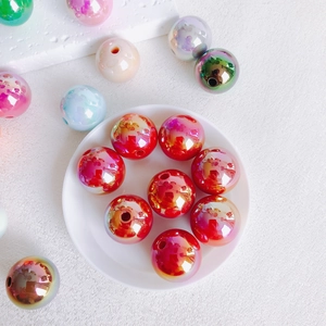 Macro shot of 16mm colorful acrylic beads with metallic luster on white tray