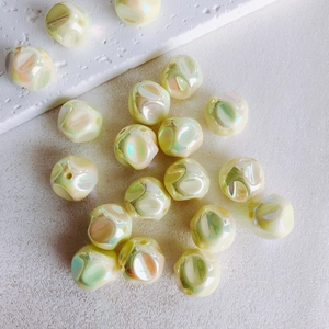 Macro shot of 16mm iridescent macaron acrylic beads with textured surface for DIY jewelry