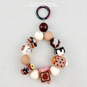 Detailed close-up of handmade acrylic dessert beads including donuts and ice cream scoops