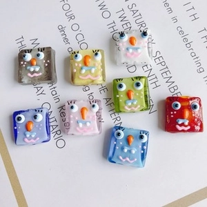 Macro shot of colorful resin cartoon monster beads with glossy finish for DIY crafts
