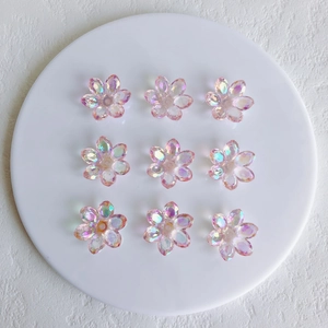 Macro detail of nine translucent aurora acrylic flower charms with iridescent AB coating
