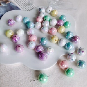 Detailed view of colorful macaron acrylic beads with white polka dots for DIY jewelry