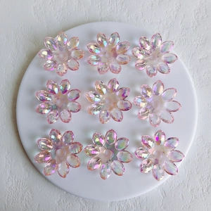 Macro shot of iridescent AB acrylic lotus flower charms for DIY jewelry making