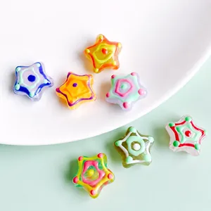 Macro shot of colorful star-shaped acrylic beads with hand-painted dots for DIY jewelry