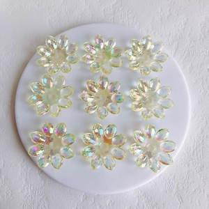 Close-up of 9 pieces of transparent aurora acrylic flower charms for DIY jewelry making