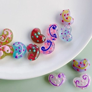 Macro shot of colorful acrylic wave beads with hand-painted dots for DIY jewelry making