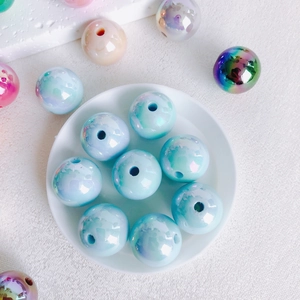 Macro shot of 16mm iridescent acrylic beads with aurora finish for DIY jewelry crafts