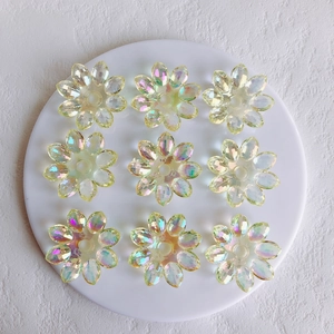 Macro detail of transparent aurora acrylic flower charms for DIY jewelry making